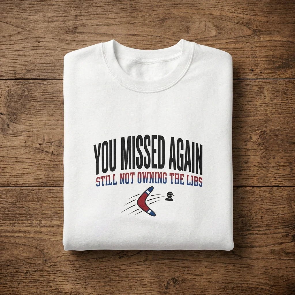 A white crewneck sweatshirt featuring the text You Missed Again Still Not Owning The Libs.