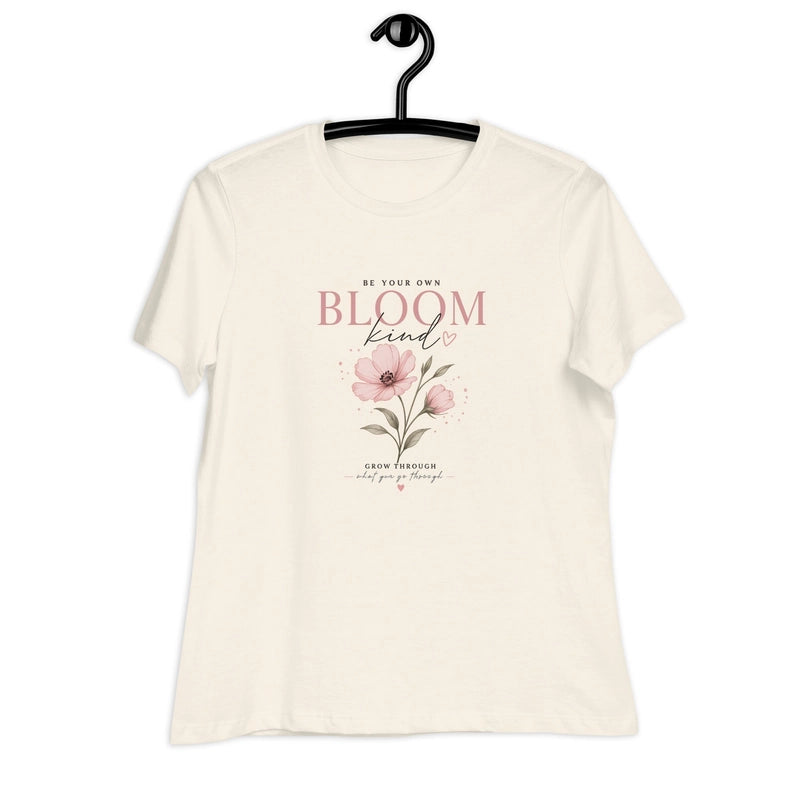 A cream-colored relaxed fit t-shirt featuring a pink floral graphic and inspirational text.