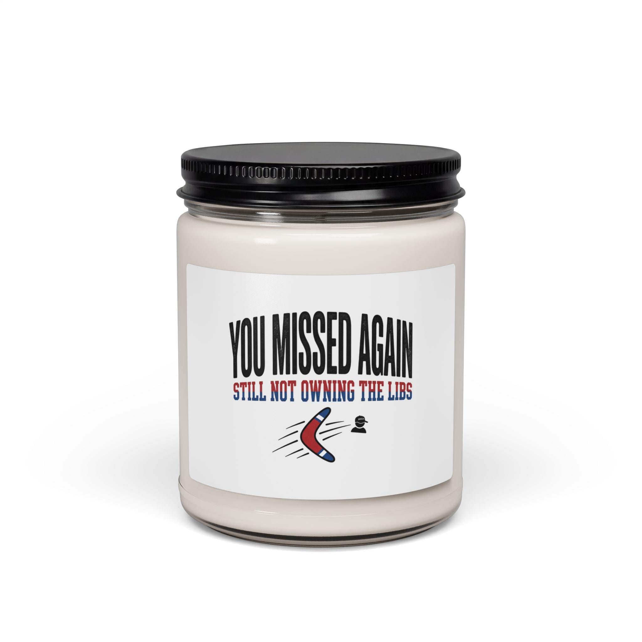A soy candle in a glass jar with a label featuring a boomerang graphic and political text.
