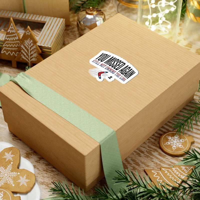 A sticker with the text You Missed Again and a boomerang graphic on a gift box.