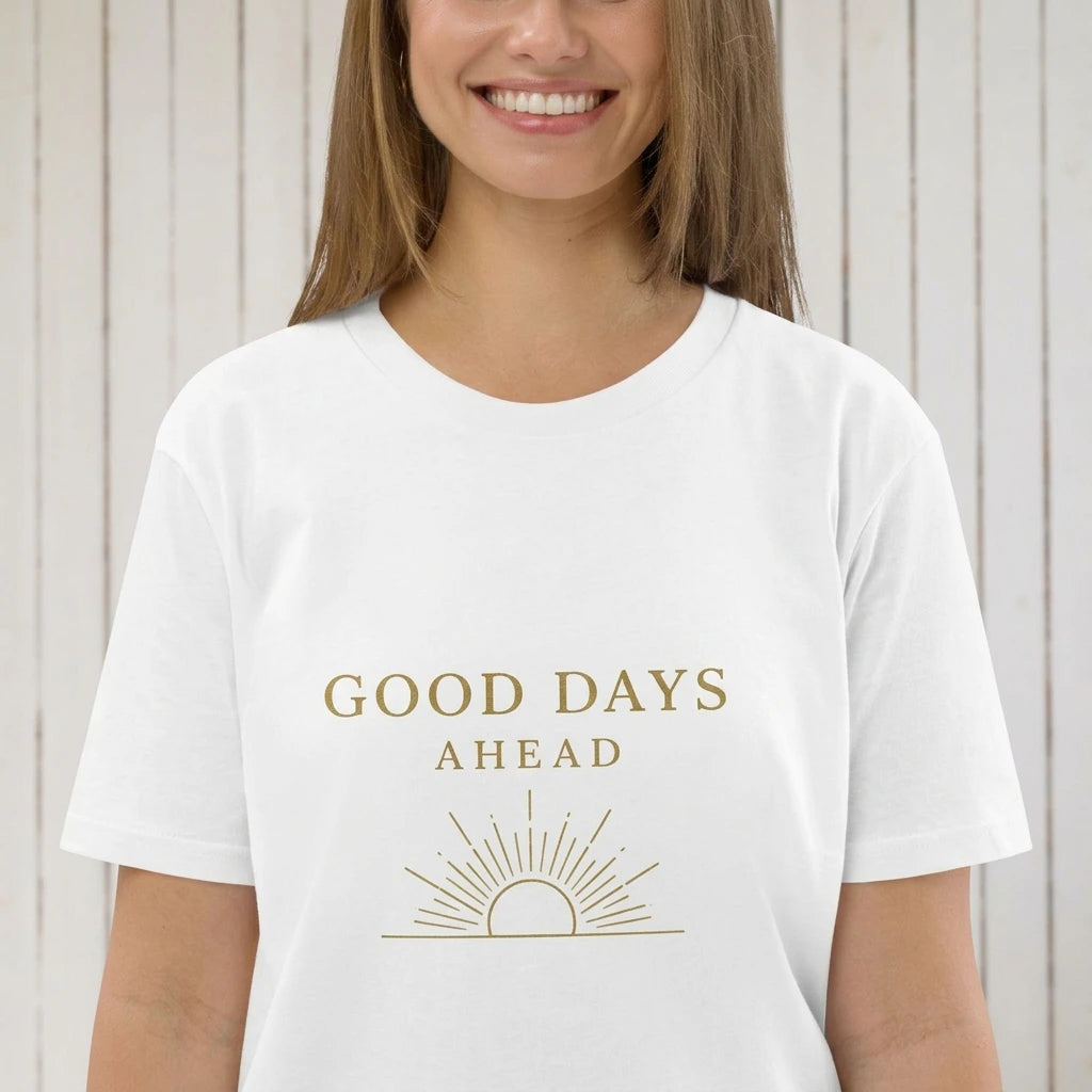 A person wears a white t-shirt featuring the text Good Days Ahead above a gold sun icon.