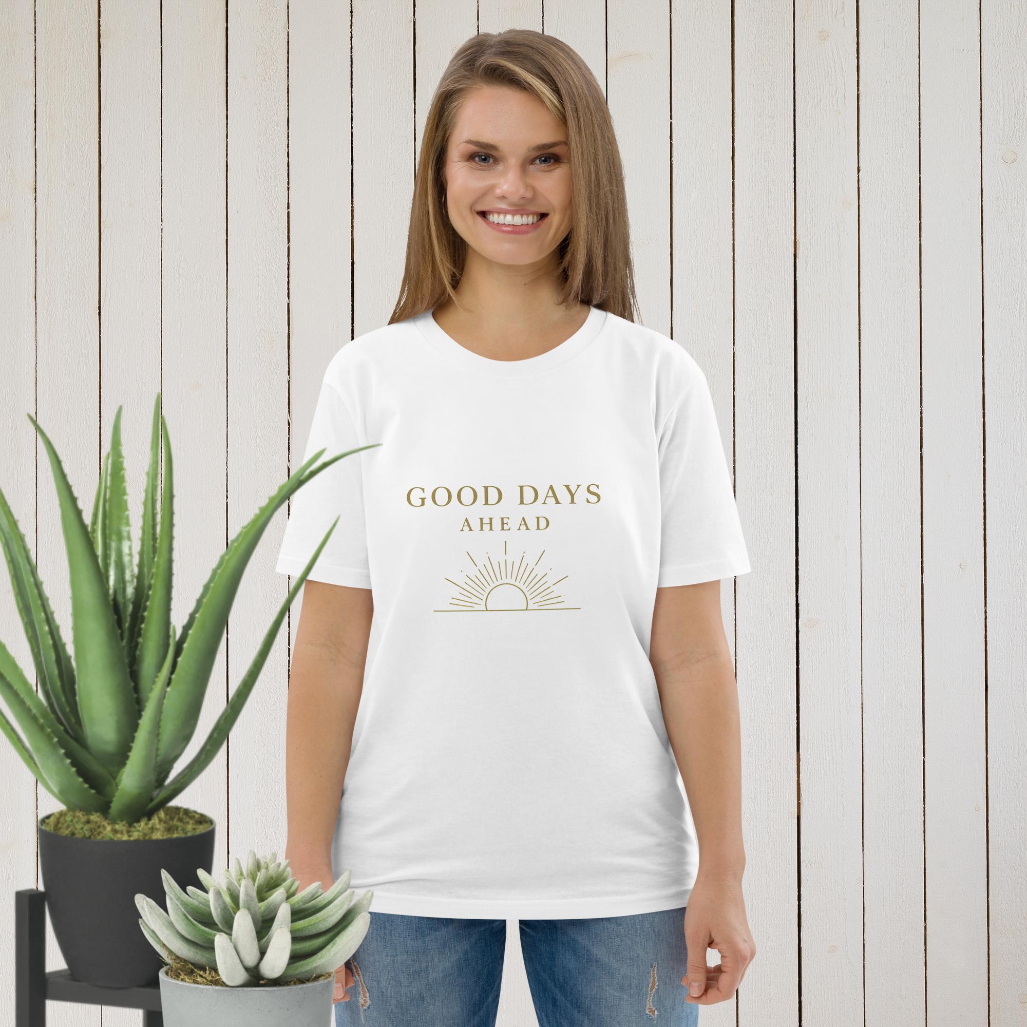 A woman wears a white t-shirt featuring a gold sun graphic and the text Good Days Ahead.